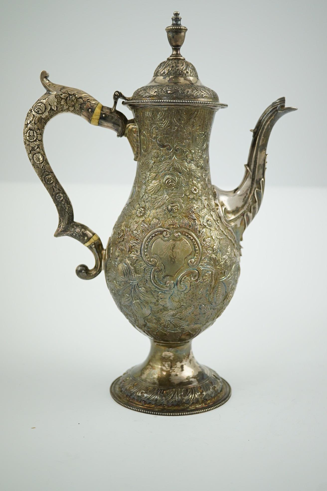 A George III silver pedestal coffee pot, with later embossed decoration